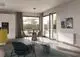 Helles, modernes Esszimmer mit Kermi Heizkörper, Tisch, Stühlen und Teppich.
