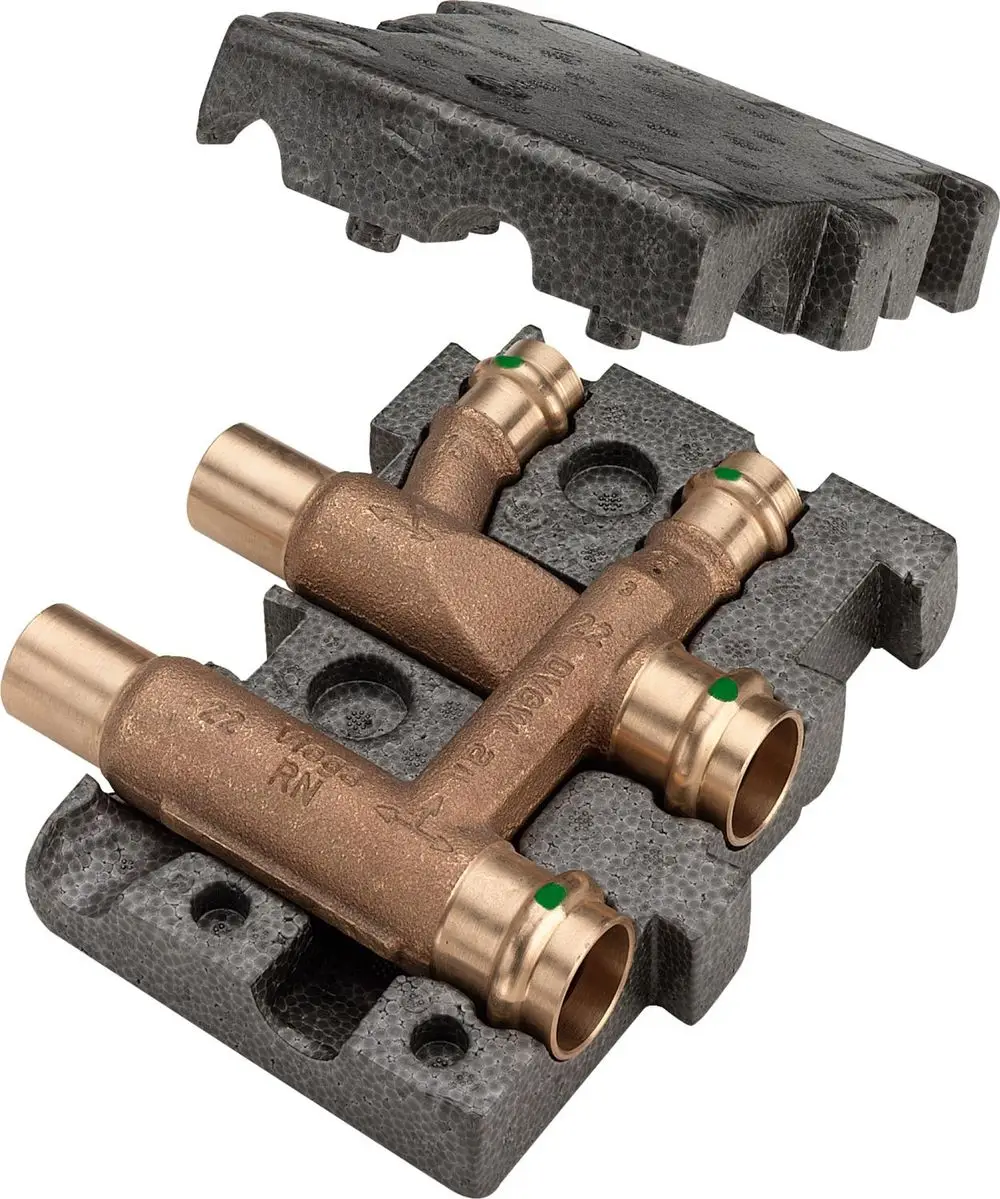 Bronze Verteiler von Viega, bestehend aus mehreren Anschlüssen für Heizungsrohre, montiert auf einer Schaumstoffunterlage.