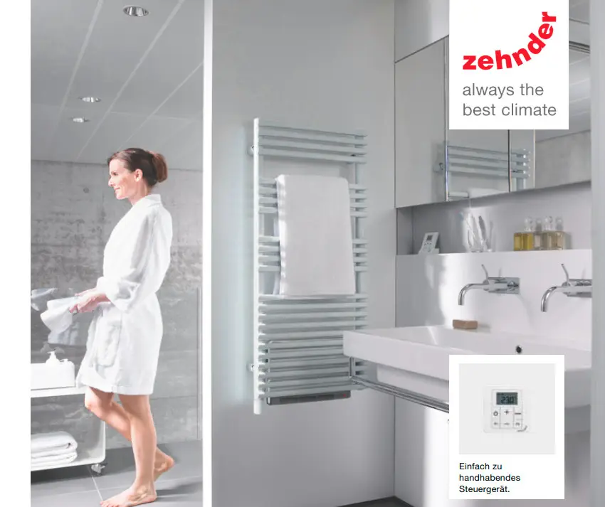 Zehnder-Heizkörper in einem Badezimmer, vertikal montiert, mit Handtuch, vor einer hellen Wand und modernen Sanitäranlagen. Person in Bademantel geht durch den Raum.