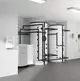 Zwei große, zylindrische Wärmepumpen mit schwarzen Rohren, installiert in einem modernen Raum. An der Wand ist ein Gerät von Stiebel Eltron zur Regelung zu sehen.