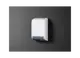 Stiebel Eltron Wandheizgerät in Weiß, flache Bauweise, montiert an einer grauen Wand, mit Lüftungsgitter und Bedienelementen auf der Oberseite.