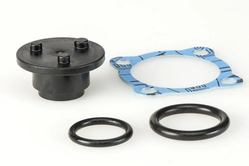 Dichtungssatz von Resideo, bestehend aus einer schwarzen Dichtung, zwei O-Ringen und einer blauen Dichtung mit Montagelöchern.