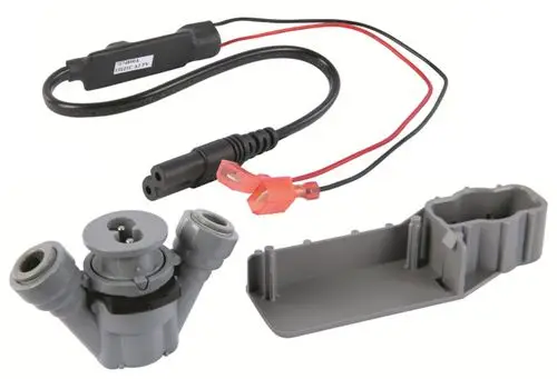 Desinfektionseinheit mit mehreren Anschlüssen und Kabeln, die zur Installation bei Resideo Produkten verwendet wird, klarer Fokus auf mechanische Komponenten.