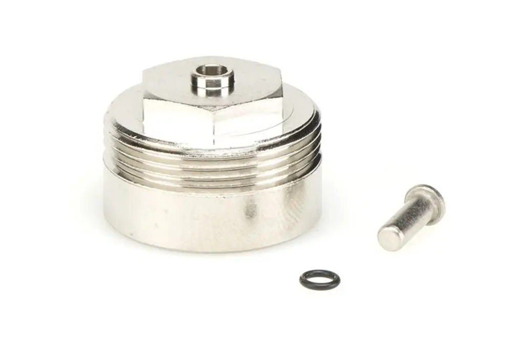 Adapter von Resideo mit einem gewinded ähnlichen Design und einem separaten Metallstift sowie einer O-Ring-Dichtung, montiert auf einer glatten Oberfläche.