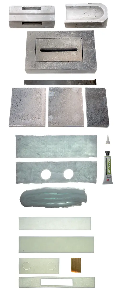 Brötje Stein-Set mit verschiedenen Betonsteinen und transparenten Platten, sowie Kleber. Anordnung der Elemente zeigt verschiedene Formen und Oberflächen.