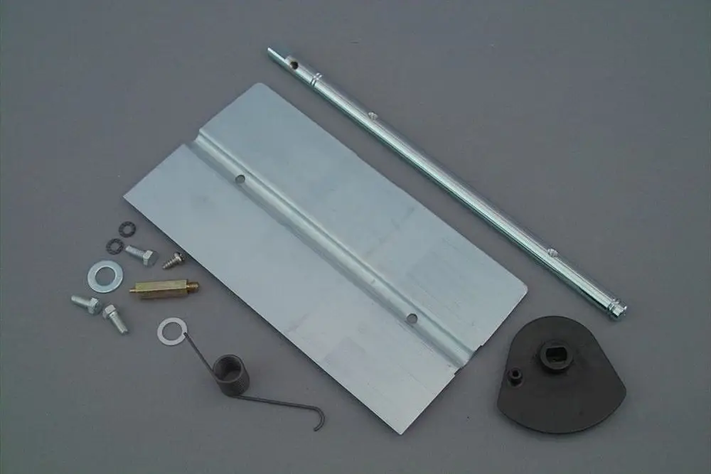 Brötje Luftklappe mit verschiedenen Montageelementen, darunter Metallteile, Schrauben und Dichtungen zur Verbindung und Steuerung in Heizsystemen.