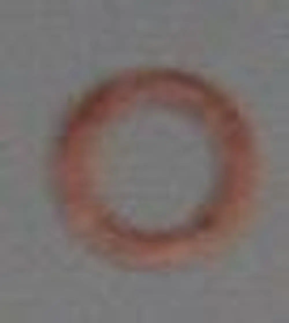 Brötje Metalldichtung, runde Form in Kupferfarbe auf grauem Hintergrund, ohne erkennbare Maße oder spezifische Merkmale.