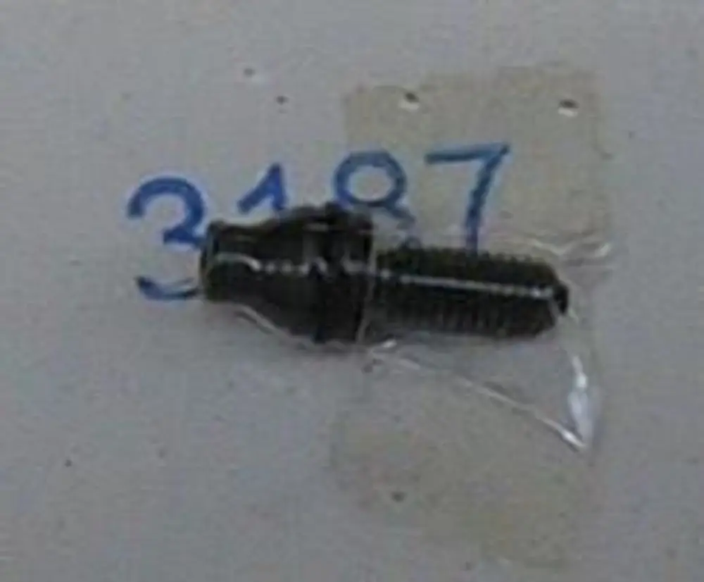 Schwarze Druckregulierschraube von Brötje in transparenter Verpackung. Schraube mit Gewinde und konischer Spitze, sichtbar beschriftet mit Nummer.