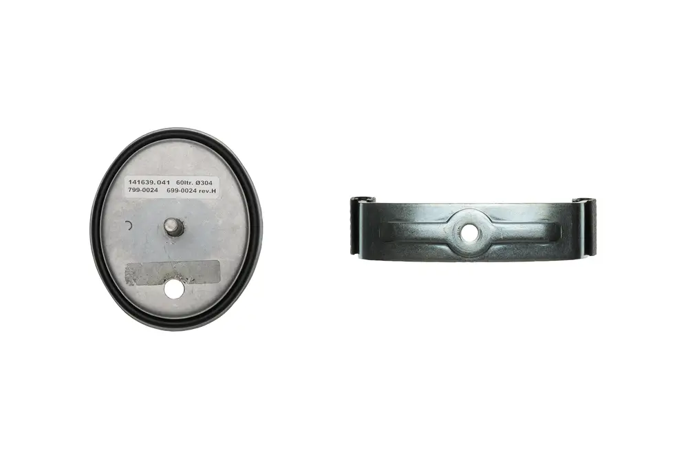 Brötje Produkt mit ovaler Metallbasis und runder Auflage. Auf der Oberfläche sind mehrere Nummern und ein ovales Loch für die Befestigung erkennbar.