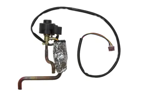 Brötje Regler mit mehreren Rohren und Elektroanschluss. Sichtbar sind eine schwarze Baugruppe sowie eine isolierte Leitung, die zur elektrischen Verbindung dient.