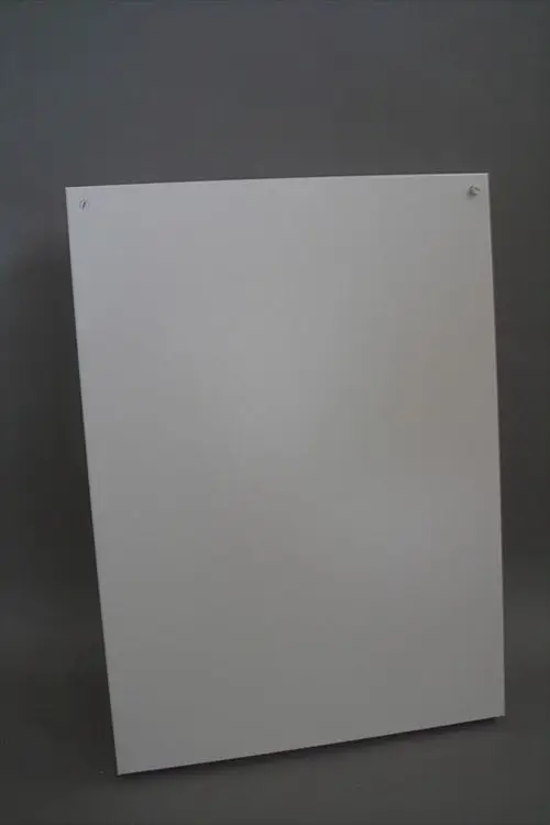 weiße Verkleidung, geeignet für die Verwendung mit Brötje Heizsystemen, montiert an einer Wand, mit zwei Befestigungslöchern oben.