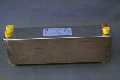 Brötje Verdampfer mit einem länglichen, metallischen Gehäuse und mehreren Anschlüssen in gelb und rot. Auf einer Seite ist ein Etikett mit technischen Informationen angebracht.