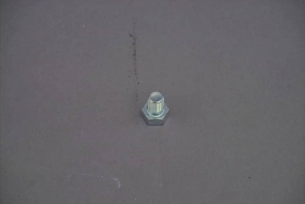 Brötje Schraube in Metalloptik auf grauem Untergrund, mit Gewinde und sechseckigem Kopf, einzeln abgebildet.
