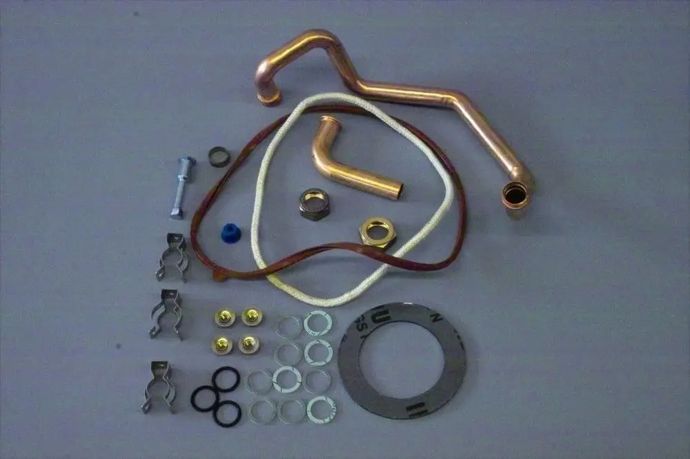 Zusammenstellung von Kupferrohren, Dichtungen, Schellen und Befestigungsteilen, die möglicherweise für die Installation oder Reparatur von Brötje-Wärmetauschern verwendet werden.