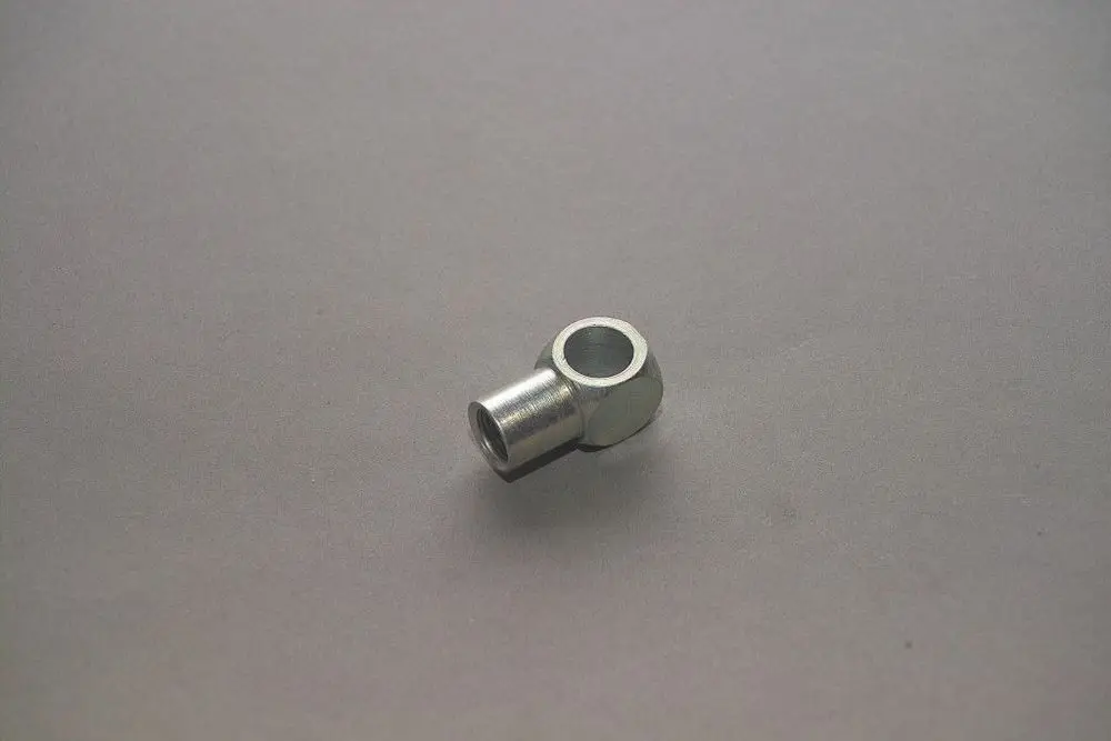 Brötje Nippel aus Metall, mit einem zylindrischen Ende und einer offenen Verbindung. Auf einem grauen Hintergrund abgebildet.