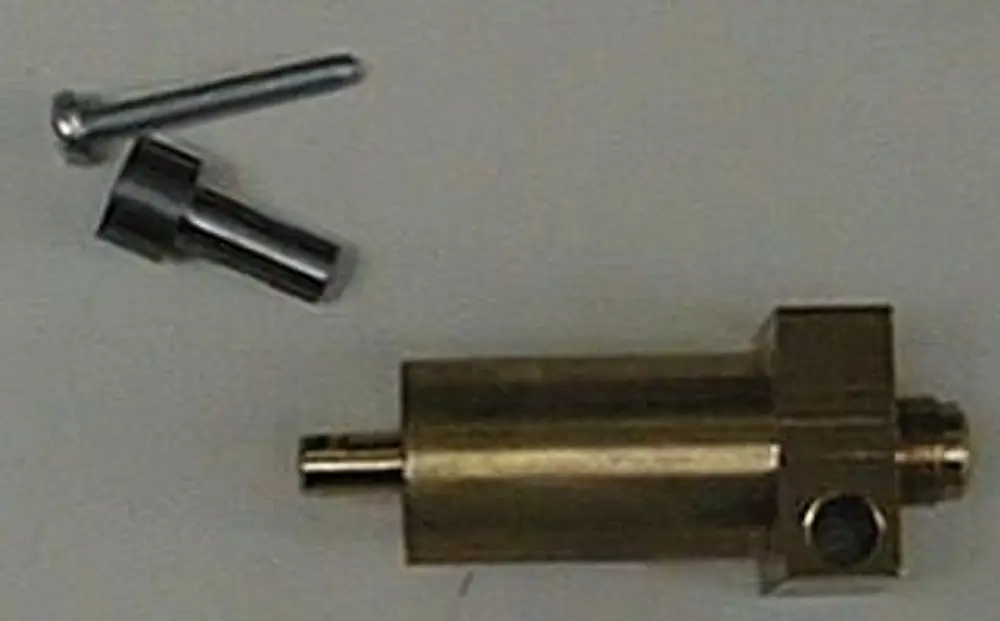 Brass pressure cylinder with an attached inlet and outlet, next to two metal components, associated with Brötje air flap mechanism.