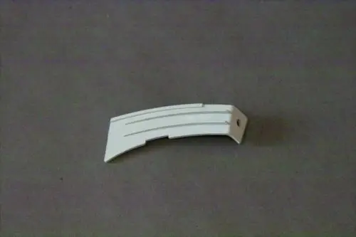 Weißes Luftleitblech von Brötje, mit gerillter Oberfläche und einer Halterung. Das Bauteil hat einen geschwungenen Verlauf und ist flach.
