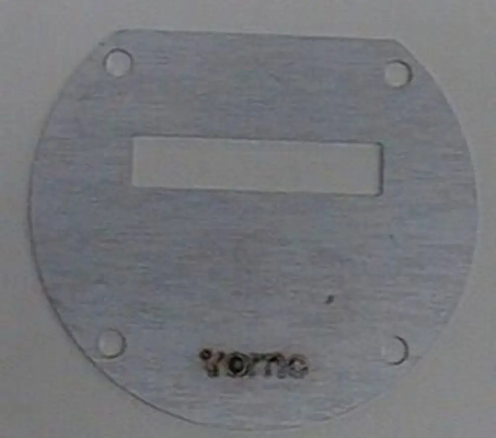Metallische Drosselblende mit ovaler Form und einer rechteckigen Aussparung, gekennzeichnet mit der Marke Brötje. Zwei Löcher zur Montage sind vorhanden.