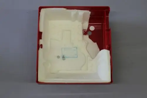 Rote Brennerhaube von Brötje, innen mit Schaumstoff ausgekleidet. Große Öffnung und mehrere Halterungen sichtbar. Unterseite mit Schriftzug und einem Schraubloch.