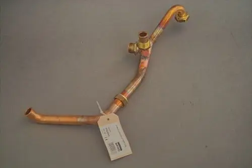 Kupfernes Rohr mit mehreren Biegungen und Anschlüssen, möglicherweise für Heizungsanwendungen, mit Etikett. Produkt von Brötje.