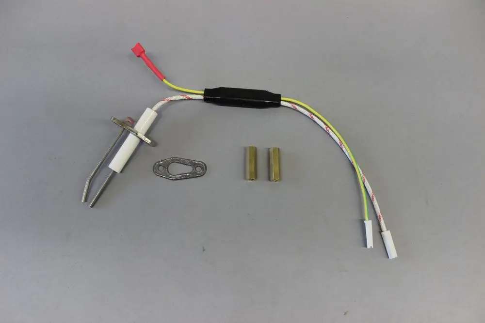Brötje Zündelektrode für Stirlingbrenner mit Anschlusskabel, zwei Verbindungselementen, einer Dichtung und einem Metalldorn.