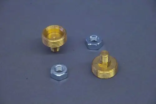 Brötje Anschlussnippel, ein Set bestehend aus zwei metallischen Verbindungsstücken, eines mit einem gerändelten Rand und einem durchgehenden Gewinde, sowie einer Mutter.