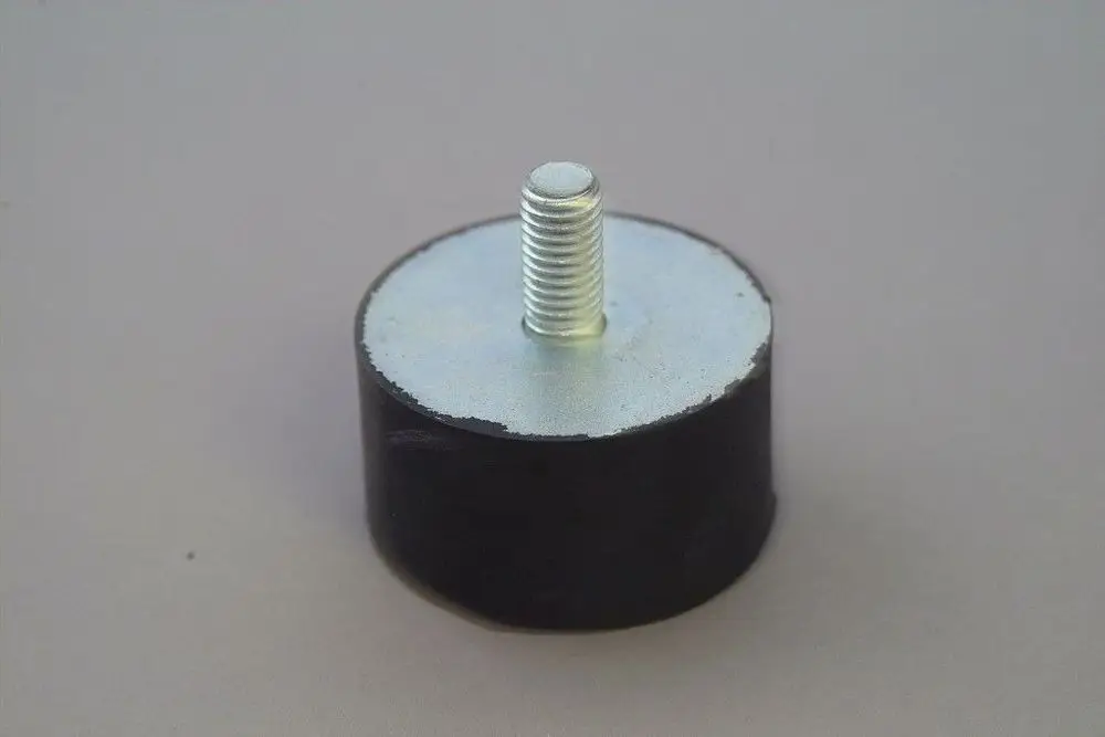 Schwingungsdämpfer in runder Form mit einem zentralen Gewinde und einer metallischen, flachen Oberseite, schwarz ummantelt. Produkt von Brötje.