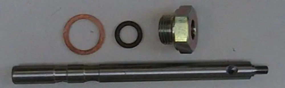Brötje Gasdrossel-Spindel mit zwei Dichtungen (einer Kupfer- und einer Gummidichtung) sowie einer Gewindemutter, angeordnet auf einer neutralen Fläche.