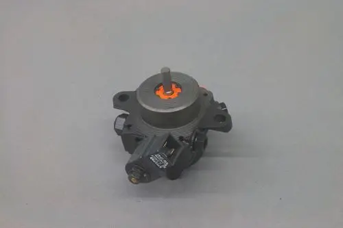 Brötje Pumpe mit zentraler Achse und seitlichem Anschluss. Die Oberflächenstruktur ist glatt, und die Anschlussstelle zeigt elektrische Komponenten.