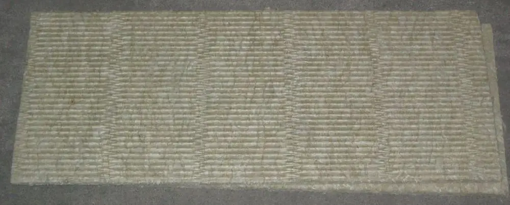 Brötje Isoliermatte in heller Farbe, mit einer gerippten Struktur und einer rechteckigen Form, auf einem grauen Untergrund ausgelegt.
