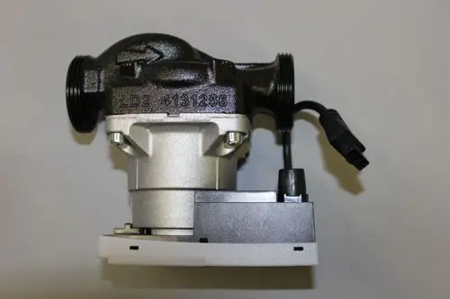 Heizungsumwälzpumpe von Brötje, ausgestattet mit Anschlussleitungen und einem elektrischen Anschluss. Gehäuse in schwarzer und silberner Farbe.