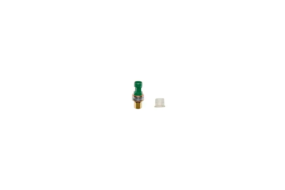 Brötje Niederdrucksensor in kompaktem Design mit grünem Element und beigem Gewinde. Neben dem Sensor befindet sich eine kleine Abdeckung.