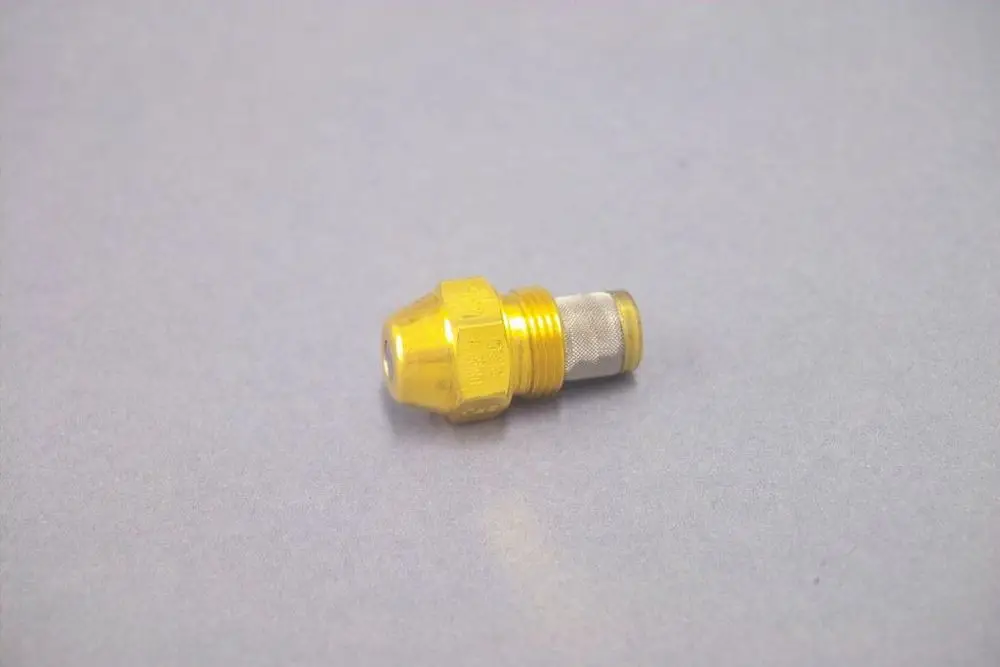 Brötje Düse in gelber Farbe mit konischem Kopf und metallem Anschluss, geeignet für Heizungsanwendungen, auf grauem Hintergrund.
