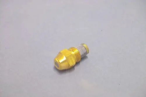 Goldfarbene Düse von Brötje, mit Gewinde und einem herausstehenden Element. Die Düse hat eine konische Form und liegt auf einem grauen Untergrund.