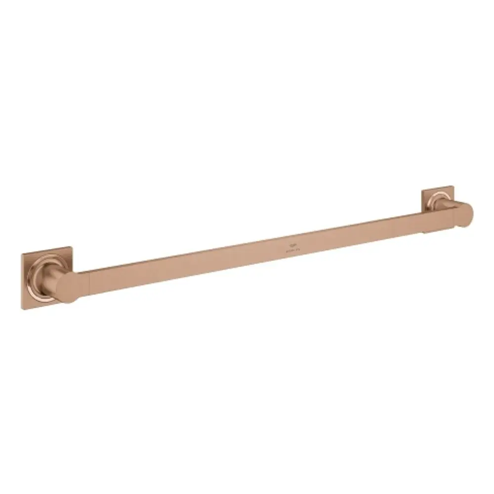 GROHE Badetuchhalter in warmer Farbgebung, mit rechteckiger Grundplatte und runden Enden, montiert an einer glatten Wandoberfläche.