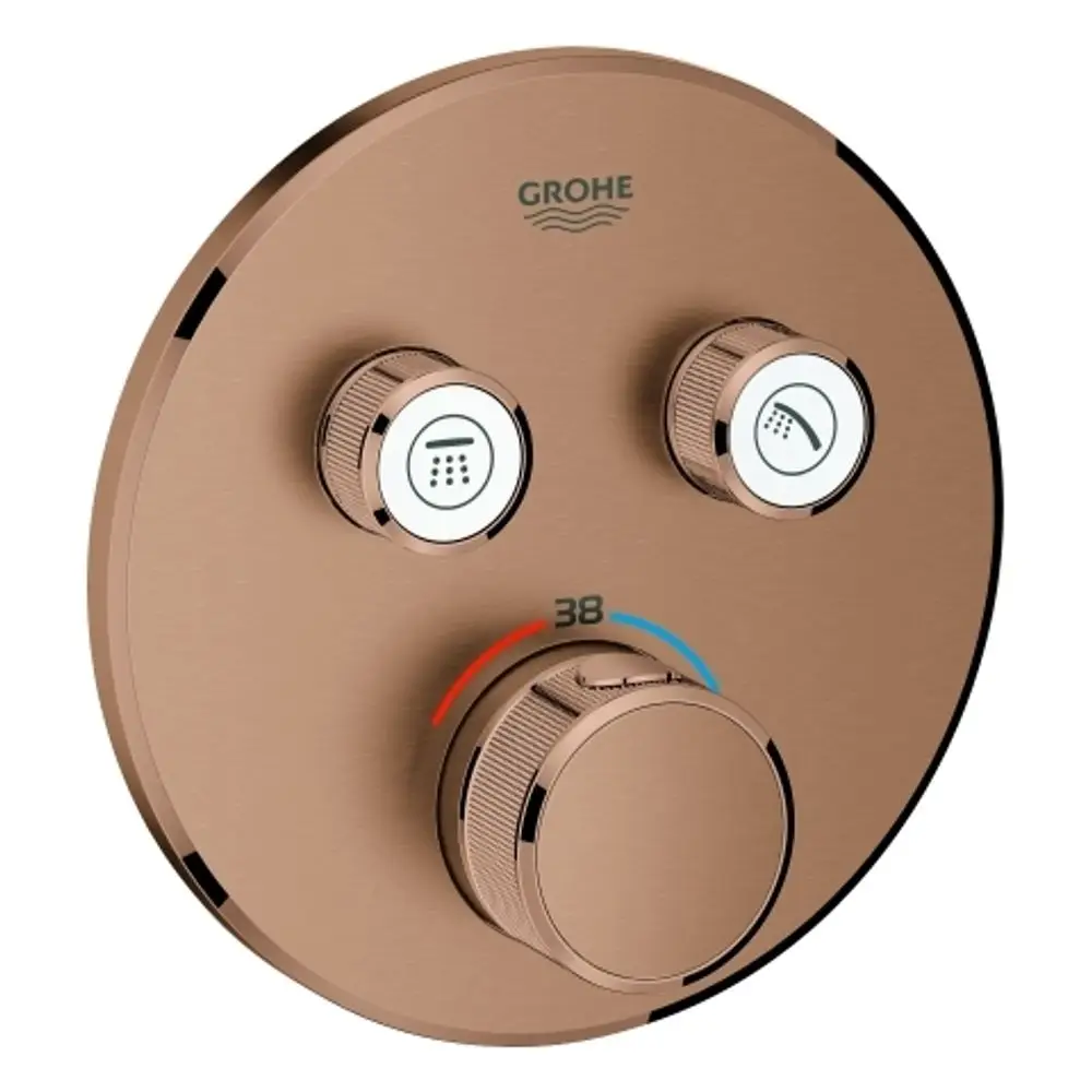 Runder Grohe Thermostat mit drei Drehknöpfen zur Temperatur- und Strahlartenregulierung, in einer warmen Farbgebung, montiert auf einer glatten Fläche.