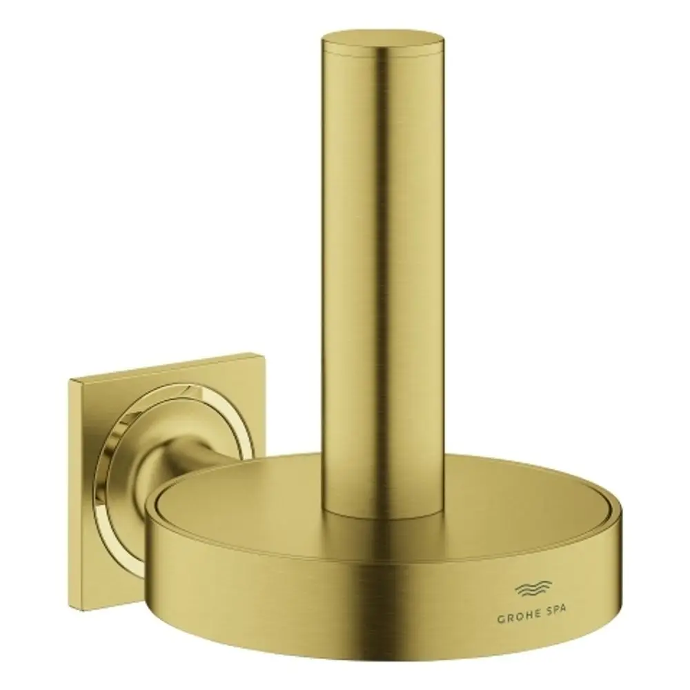 GROHE WC-Reservepapierhalter in gebürstetem Gold mit kreisförmiger Basis und senkrechtem Ständer, montiert auf quadratischer Wandplatte.