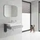 GROHE-Waschtisch mit Einhandbatterie, montiert an einer grauen Wand. Im Hintergrund zwei Fenster mit Jalousien und ein hölzerner Hocker mit Badezimmerartikeln.