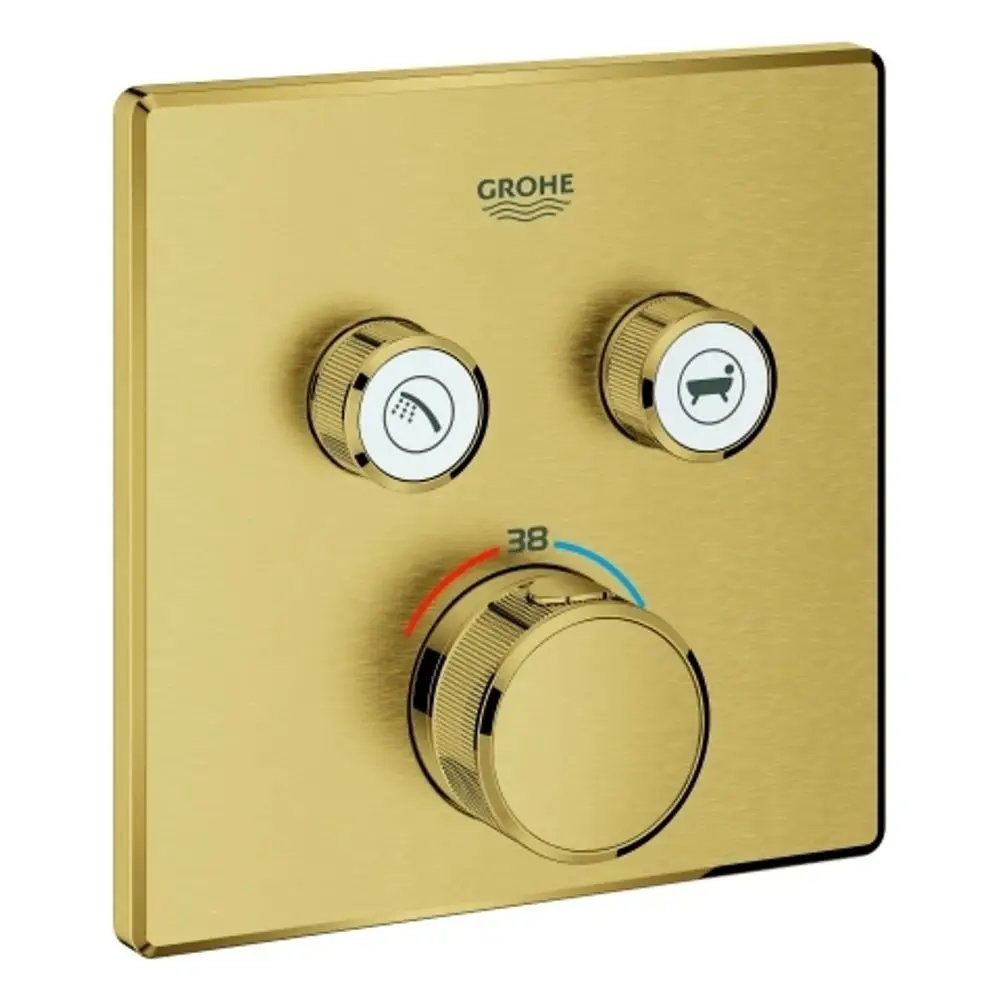 GROHE Thermostat mit drei Reglern, einem Drehknopf zur Temperatureinstellung und Symbolen für Dusche und Badewanne auf einer goldfarbenen Oberfläche.