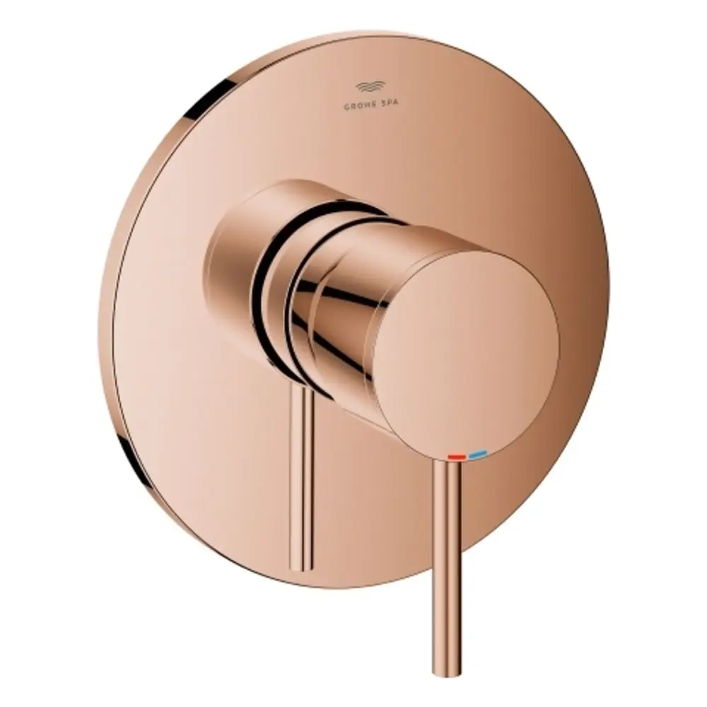 Wandmontierte Grohe-Armatur in Roségold mit einem runden Bedienknopf und zwei Skalen für Warm- und Kaltwasser. Minimalistisches Design ohne sichtbare Anschlüsse.