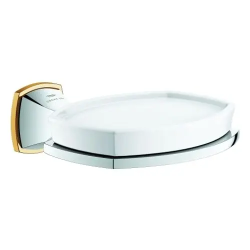 Seifenschale mit Halterung in chrom und gold, entworfen von Grohe. Die Halterung ist an der Wand montiert und ermöglicht die Nutzung der Schale für Seife oder ähnliche Gegenstände.