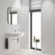 Wandmontierte Waschtischarmatur von Grohe mit einem modernen Design, installiert über einem weißen Waschbecken, in einem hellen Badezimmer mit Fenster und minimalistischem Mobiliar.