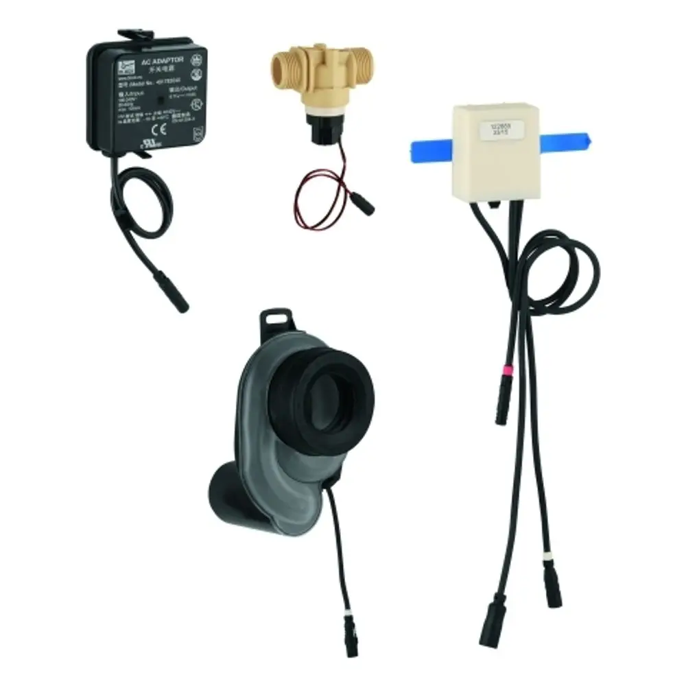 Vier elektronische Komponenten, darunter ein Temperatursensor von Grohe, ein Trafo und weitere Teile mit Kabeln für eine Urinalinstallation.