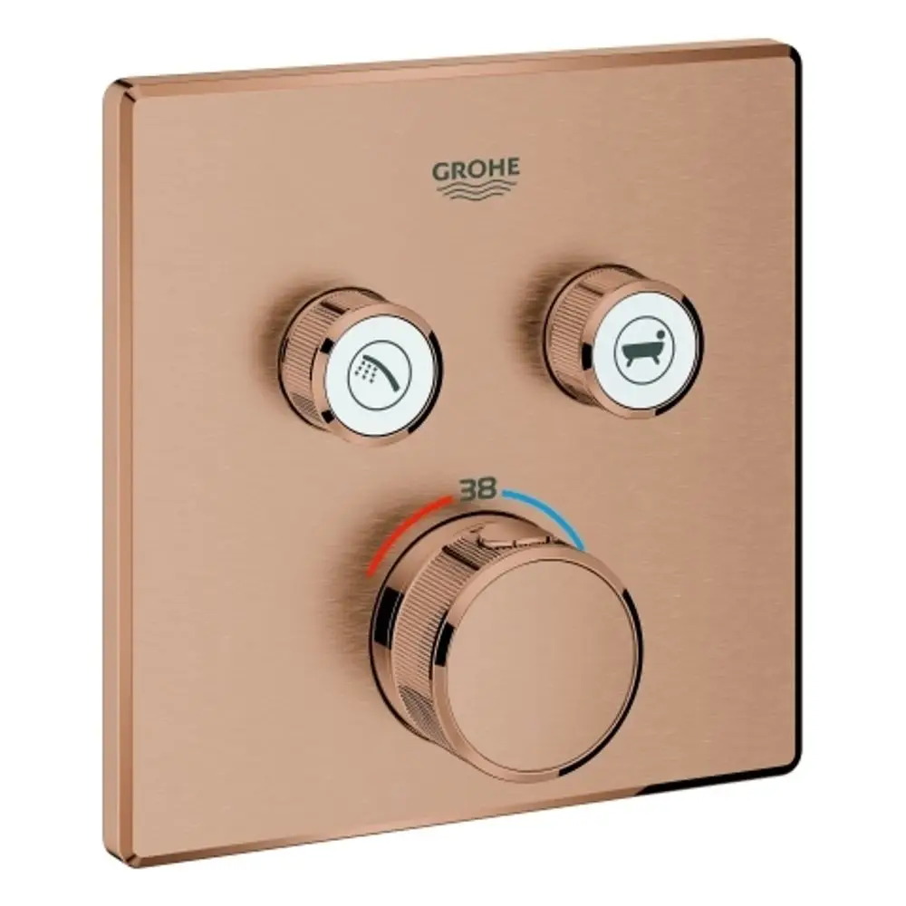 Thermostat von Grohe mit drei Bedienknöpfen auf rechteckiger Fläche in Roségold. Ein Drehregler für die Temperatur und zwei Schalter für Dusche und Badewanne.
