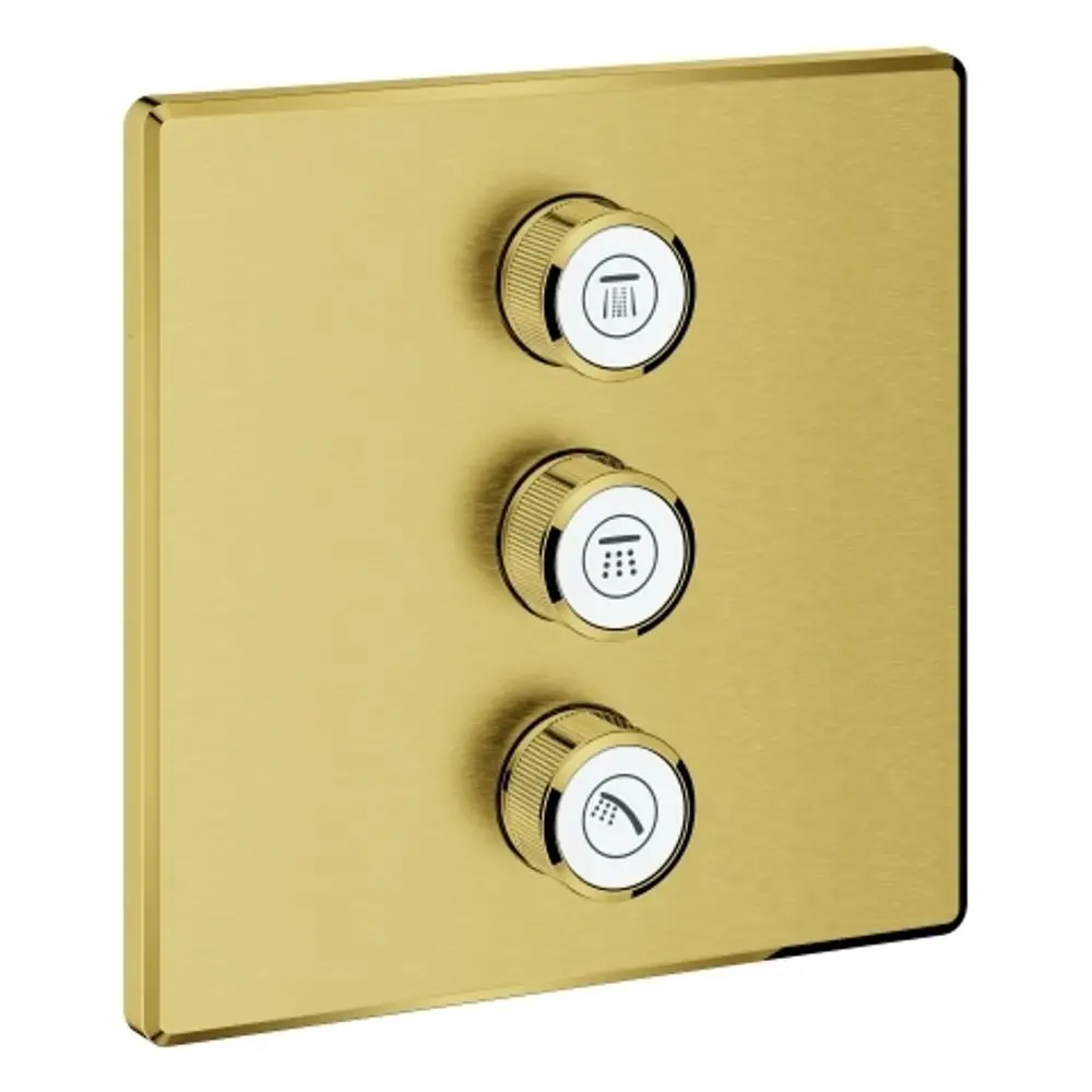 Drei Drehregler auf einer goldenen Oberfläche, die zur Steuerung von Wasserströmen dienen, mit Symbolen für verschiedene Ausgänge, hergestellt von Grohe.