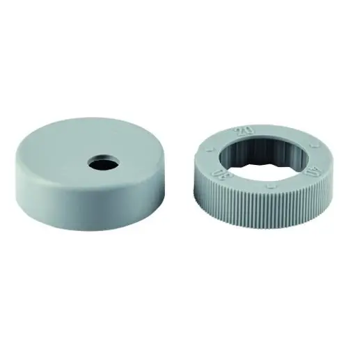 Zwei graue Kunststoffteile, ein flacher Deckel und ein gewellter Ring mit Aussparung in der Mitte, möglicherweise für Grohe Armaturen.