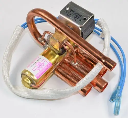 Remko 4-Wege-Umkehrventil mit Kupferleitungen und elektrischen Anschlüssen. Das Ventil zeigt verschiedene Rohrleitungen und einen Steuermechanismus.