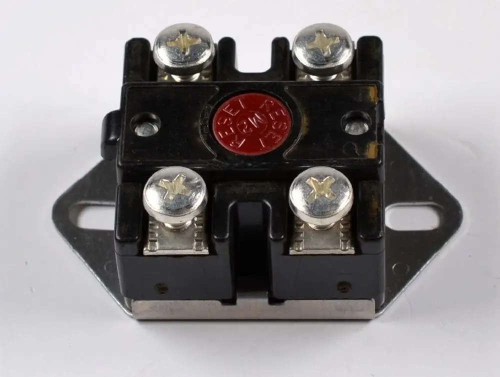 Temperatursensor von Remko mit vier Anschlüssen, einem roten Druckknopf oben und einer Metallbasis zur Montage. Funktioniert als Sicherheitstemperaturbegrenzer.