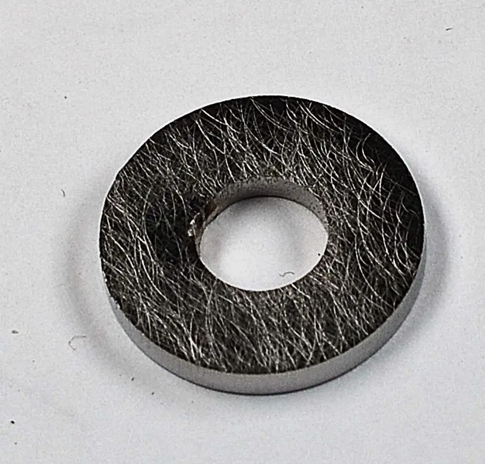 Gasmembran in rundem Design mit zentralem Loch, hergestellt von Remko. Material sieht strukturiert aus, geeignet für verschiedene Anwendungen.