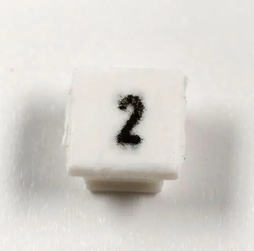Weiße Klemmenmarkierung mit der Zahl 2 in schwarzer Schrift, geeignet für die Kennzeichnung von Leitungen oder Anschlüssen. Marke: Remko.